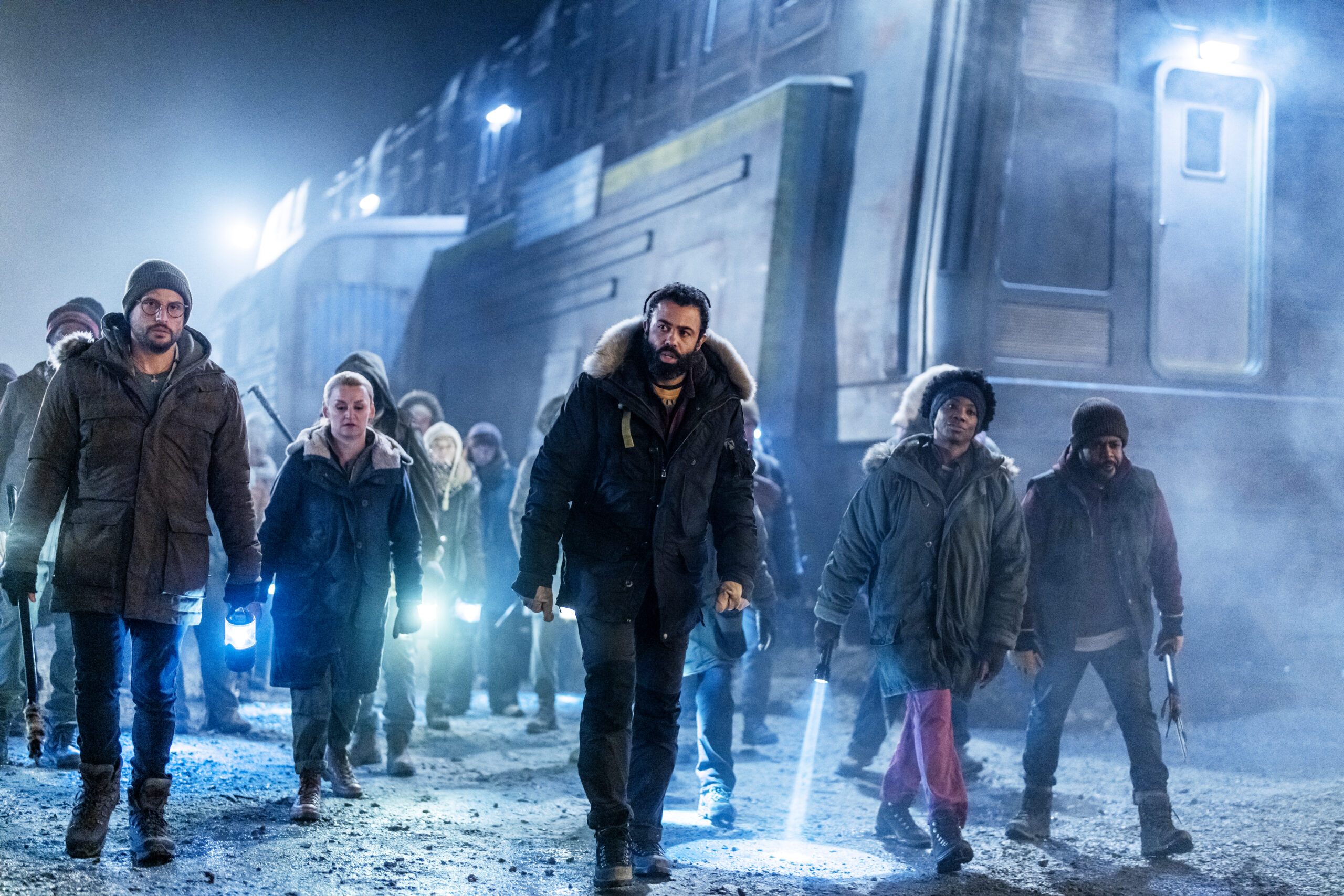 Snowpiercer Season 4 Episode 1 - Daveed Diggs, Alison Wright, Roberto Urbina, Kwasi Thomas, and Miranda Edwards | Tell-Tale TV Still from Snowpiercer Season 4 Episode 1 of Daveed Diggs, Alison Wright, Roberto Urbina, Kwasi Thomas, and Miranda Edwards pictured from left to right.