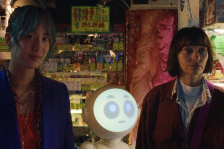 Mixxy, Sunny (a robot), and Suzie stand in a dimly lit store in Japan on Sunny Season 1 Episode 3, "Mmmm Hinoki."