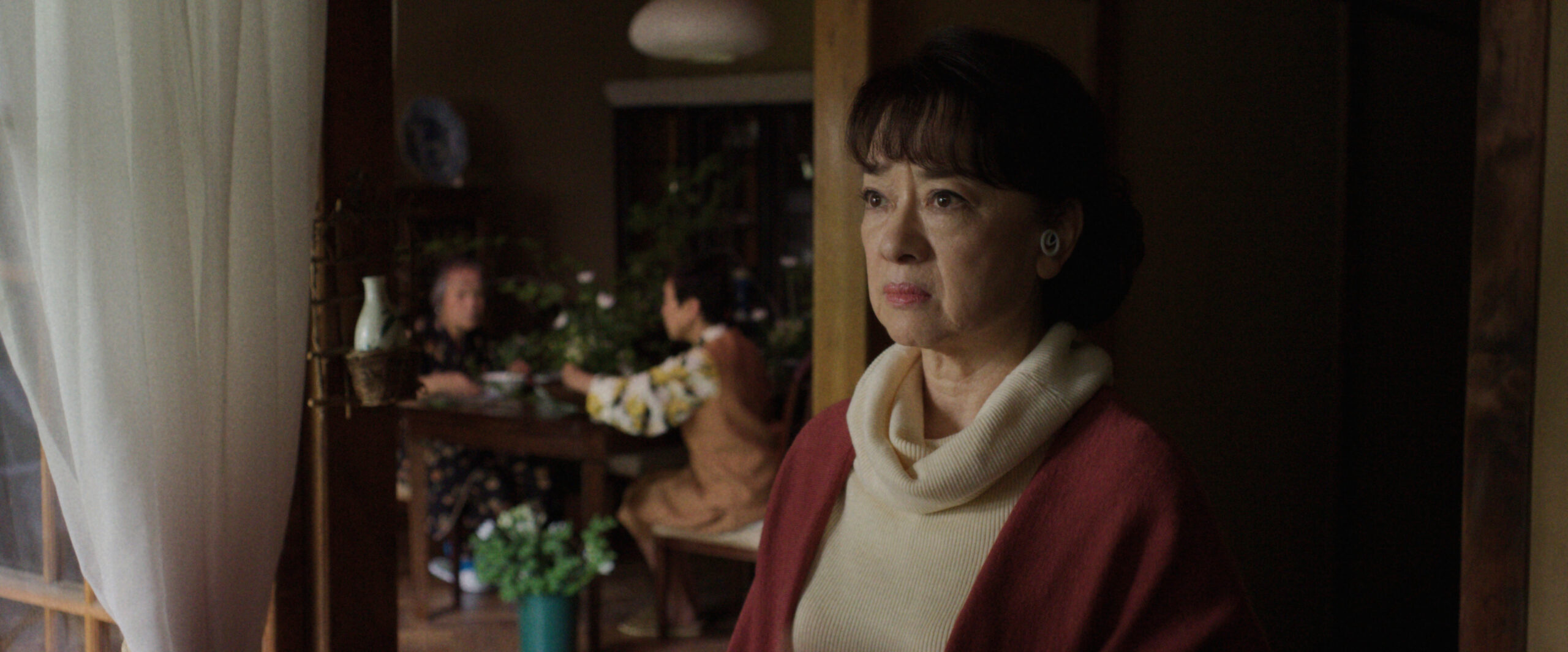 Sunny Season 1 Episode 3 Mmmm Hinoki | Tell-Tale TV Noriko Sakamoto looks upset while talking to someone off-screen as she stands in the doorway of her home on Sunny Season 1 Episode 3, "Mmmm Hinoki."