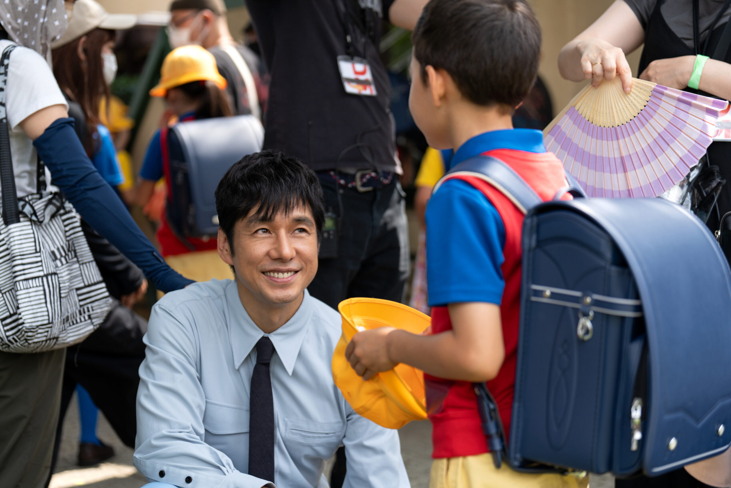 Masa kneels down and smiles up at his son, Zen, while sending him off to school on Sunny Season 1 Episode 4, "Sticky."