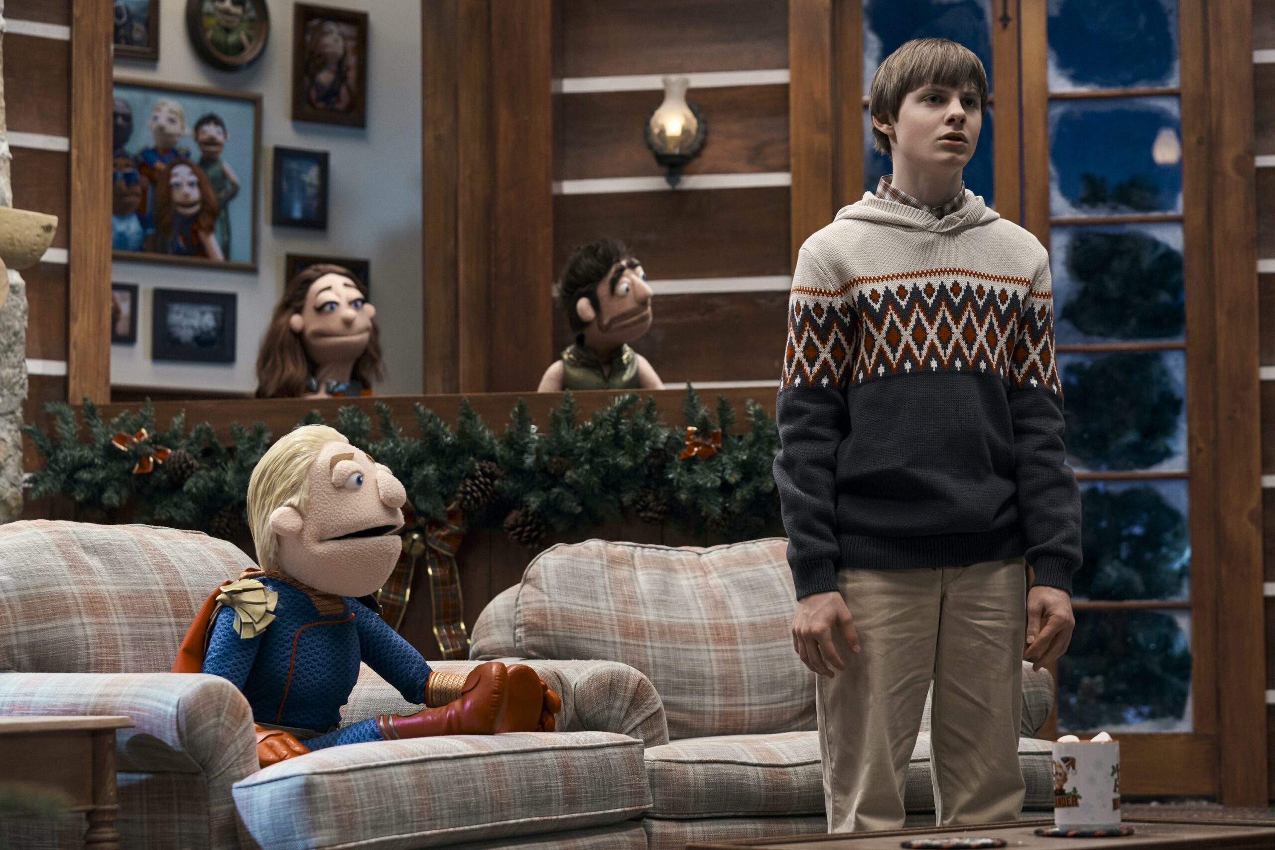 The Boys Season 4 Episode 7 - Cameron Crovetti | Tell-Tale TV Still from The Boys Season 4 Episode 7 of Cameron Crovetti as Ryan standing next to a puppet version of Homelander and in front of two other puppet versions of characters.