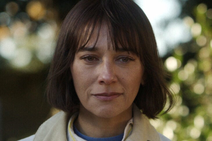 A closeup of Suzie's face as she looks emotional while standing outside on Sunny Season 1 Episode 10, "The Dark Manual."
