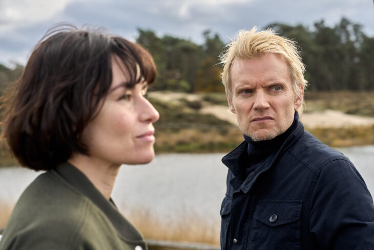 Still from VAN DER VALK SEASON 4 EPISODE 3 of Maimie McCoy as Lucienne Hassell and Marc Warren as Piet Van der Valk pictured from left to right.
