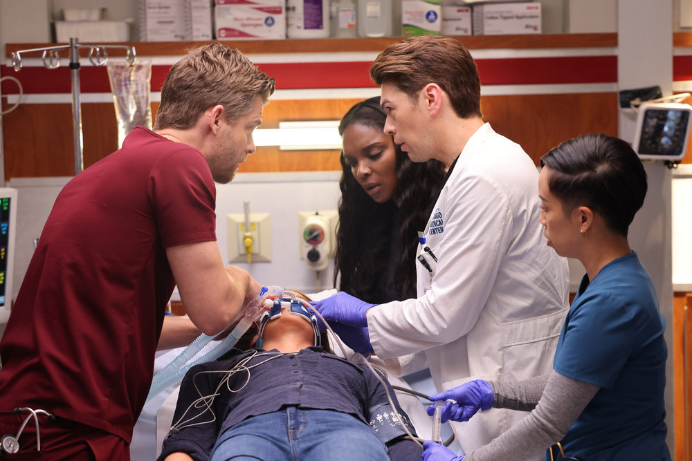 CHICAGO MED -- "Blurred Lines" Episode 1004 -- Pictured: (l-r) Luke Mitchell as Dr. Mitch Ripley, Marlyne Barrett as Maggie Lockwood, Devin Kawaoka as Dr. Kai Tanaka-Reed