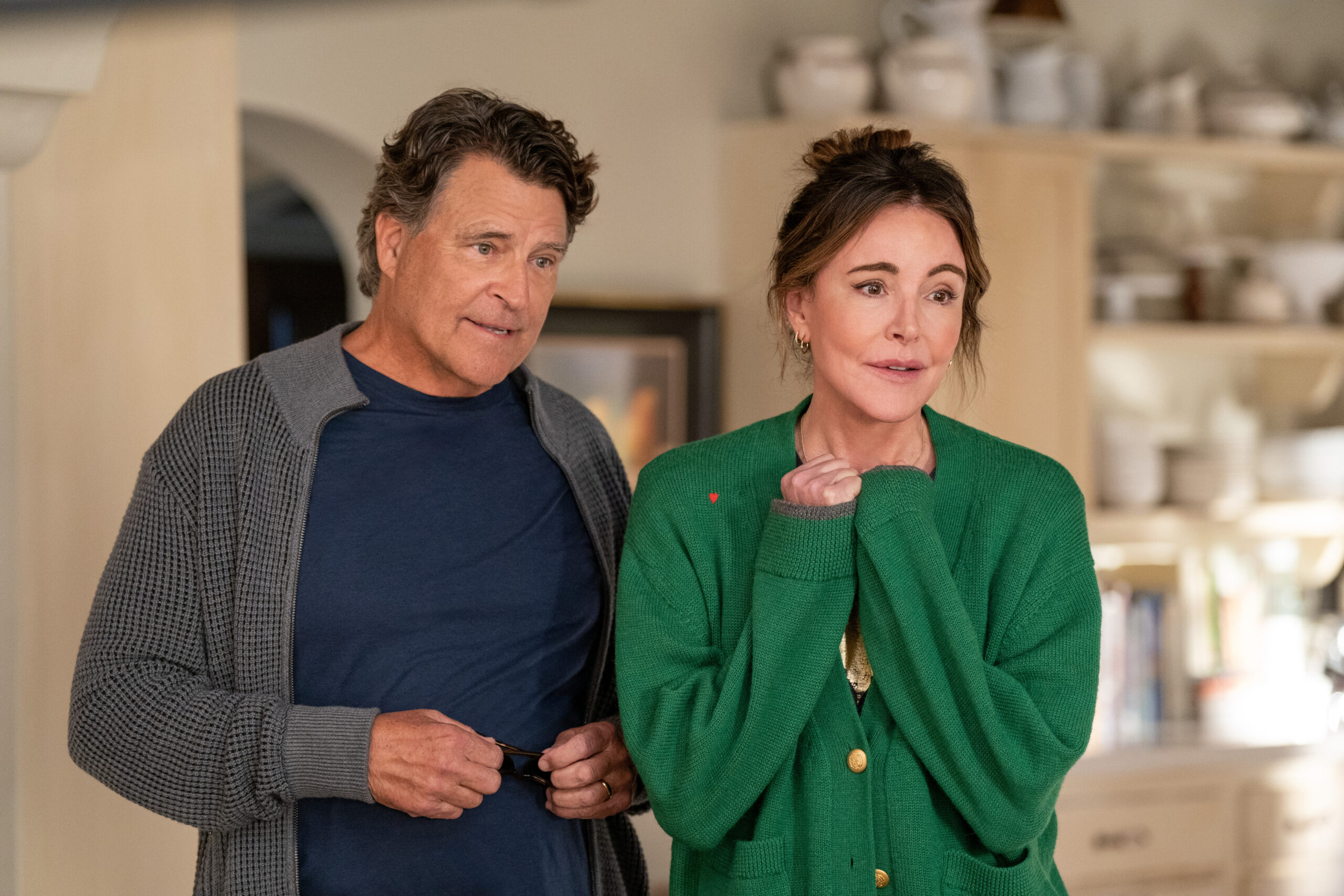 Shrinking Season 2 Episode 2 I Love Pain | Tell-Tale TV Derek and Liz look intently at Sean, who's off-screen, while standing in their kitchen on Shrinking Season 2 Episode 2, "I Love Pain."