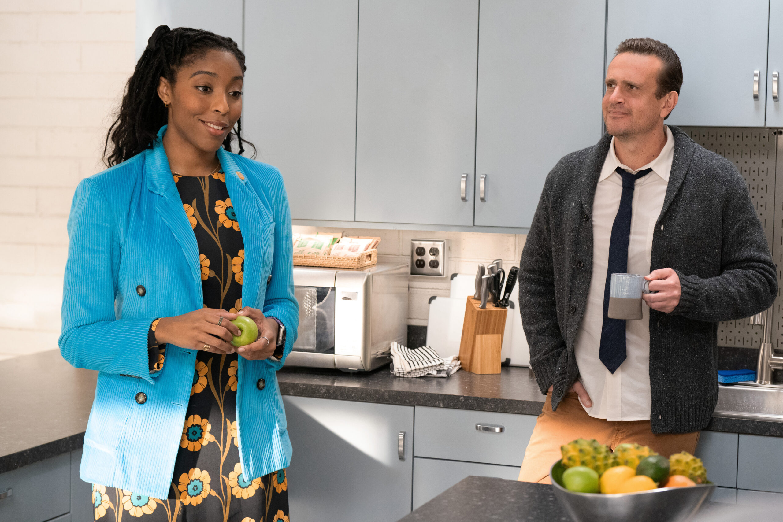 Shrinking Season 2 Episode 3 Psychological Something-ism (3) | Tell-Tale TV Gaby and Jimmy stand in the kitchen of the employee breakroom at their private practice on Shrinking Season 2 Episode 3, "Psychological Something-ism."