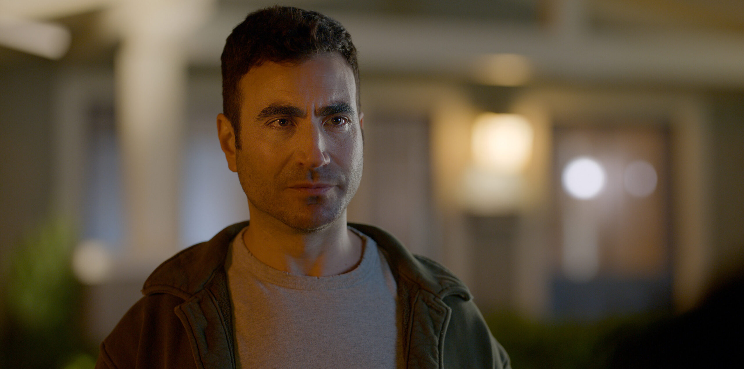 Shrinking Season 2 Episode 4 Made You Look | Tell-Tale TV Louis stands outside in a residential neighborhood at night on Shrinking Season 2 Episode 4, "Made You Look."