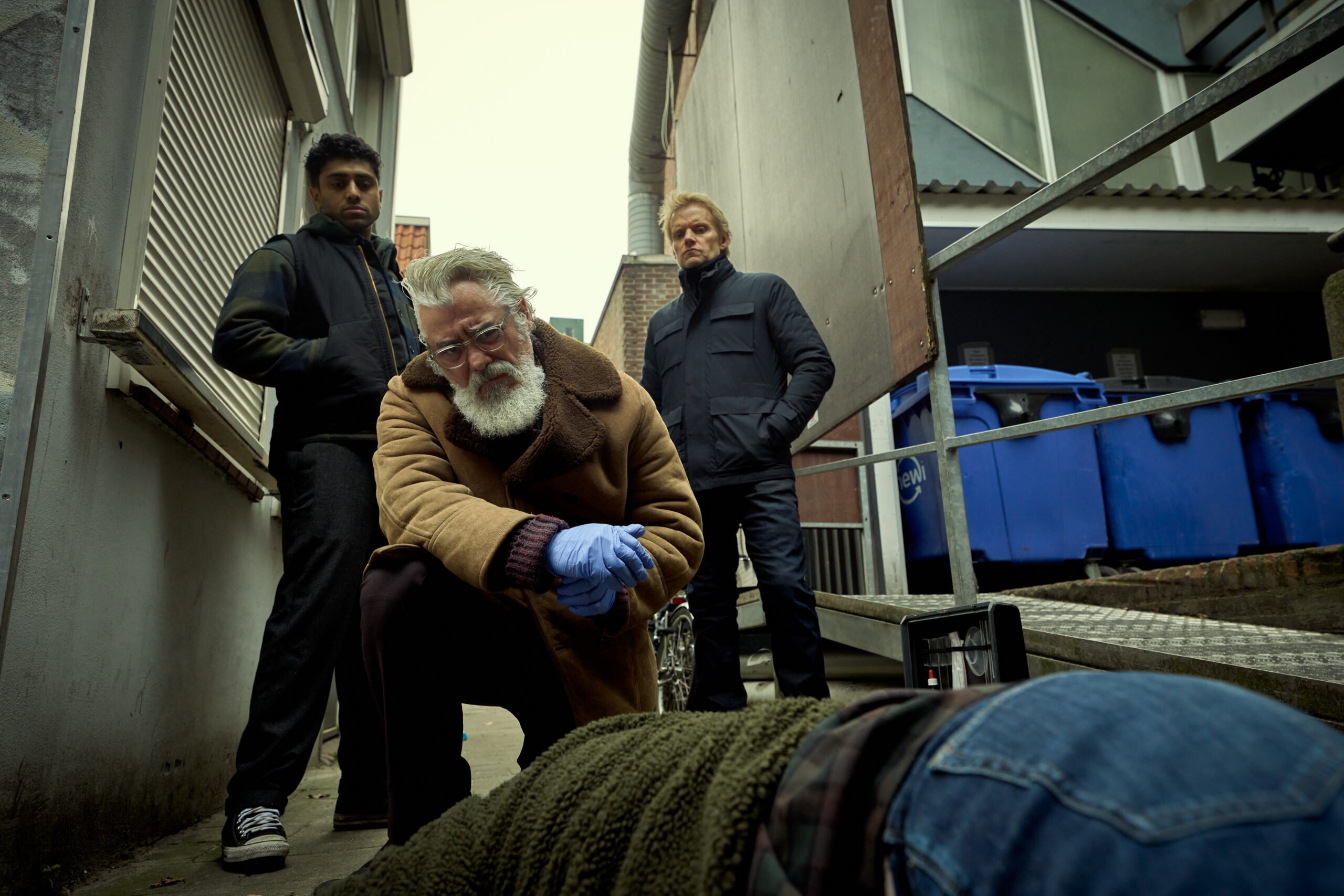 VAN DER VALK SEASON 4 EPISODE 5 - Eddie Suleman, Hendrik Davie, and Piet Van der Valk__ | Tell-Tale TV Still from VAN DER VALK SEASON 4 Episode 5 of Azan Ahmed as Eddie Suleman, Darrell D'Silva as Hendrik Davie, and Marc Warren as Piet Van der Valk pictured from left to right.