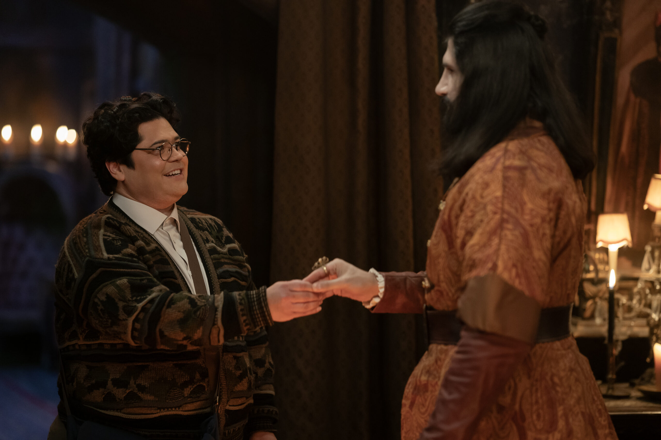 WWD6-Eps603-0531r | Tell-Tale TV Guillermo and Nandor shake hands while gazing into each other's eyes on What We Do in the Shadows Season 6 Episode 3, "Sleep Hypnosis."