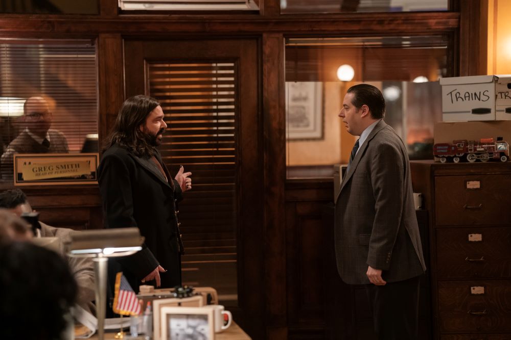 Laszlo and Sean stand in the office of a railroad company on We Do in the Shadows Season 6 Episode 4, "The Railroad."