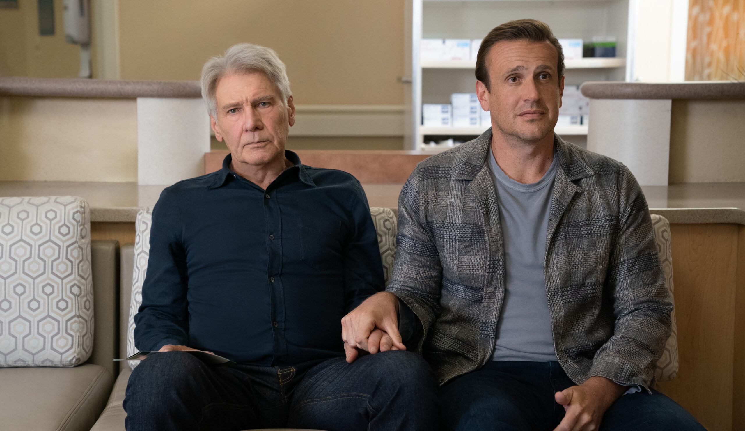 Paul and Jimmy sit in a hospital waiting room while holding hands on Shrinking Season 2 Episode 6, "In a Lonely Place."