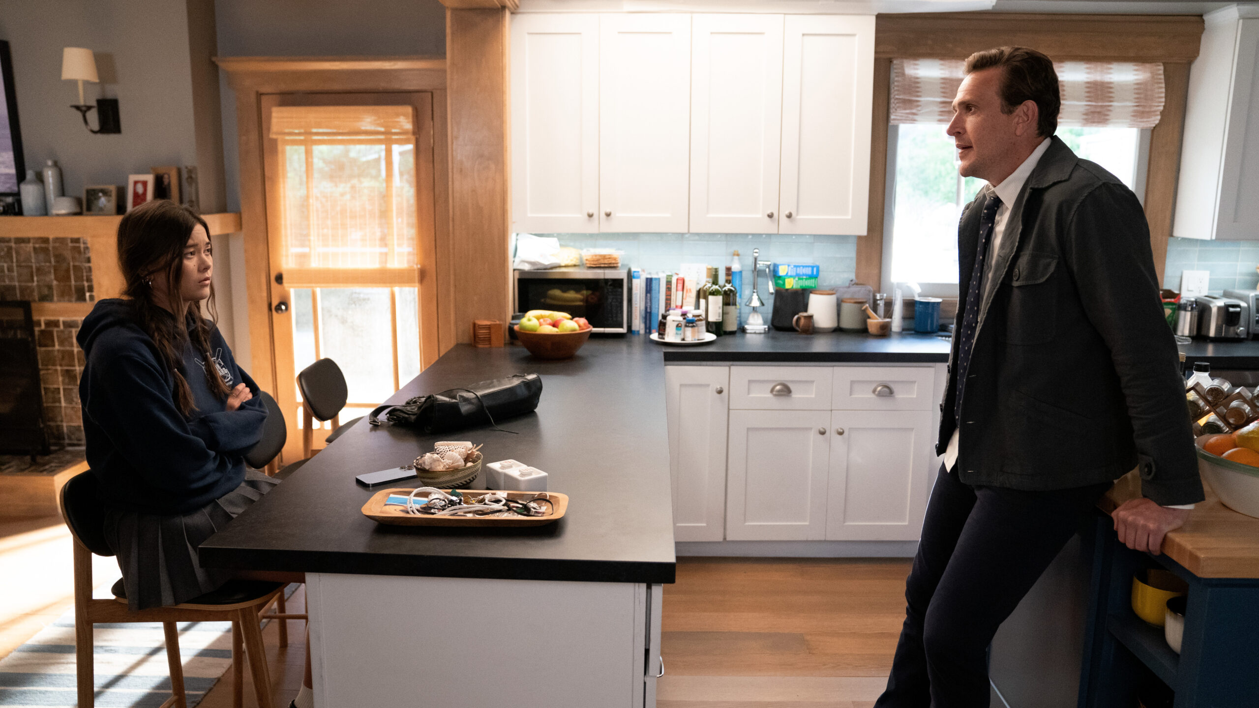Shrinking Season 2 Episode 7 Get in the Sea | Tell-Tale TV Alice sits at a kitchen island while her father, Jimmy, stands in the kitchen proper. Both are engaged in a serious conversation on Shrinking Season 2 Episode 7, "Get in the Sea."