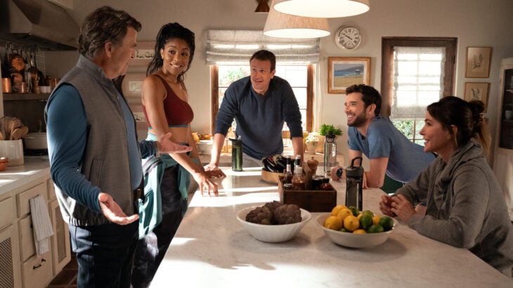 Derek, Gaby, Jimmy, Brian and Liz stand around a kitchen island in a brightly lit house in exercise gear on Shrinking Season 2 Episode 7, "Get in the Sea."