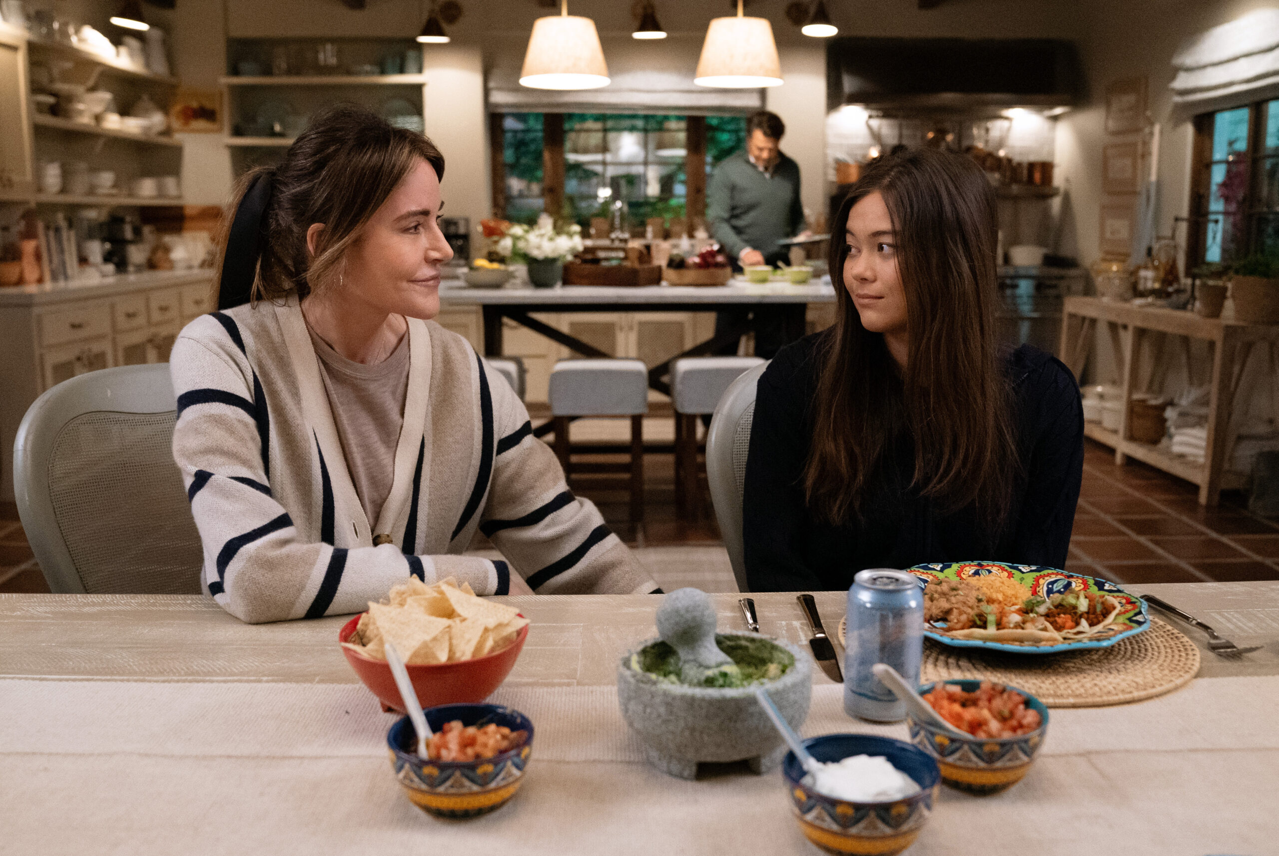 Shrinking Season 2 Episode 8 Last Drink (2) | Tell-Tale TV Liz and Alice sit at the kitchen table with taco fixings on it on Shrinking Season 2 Episode 8, "Last Drink."