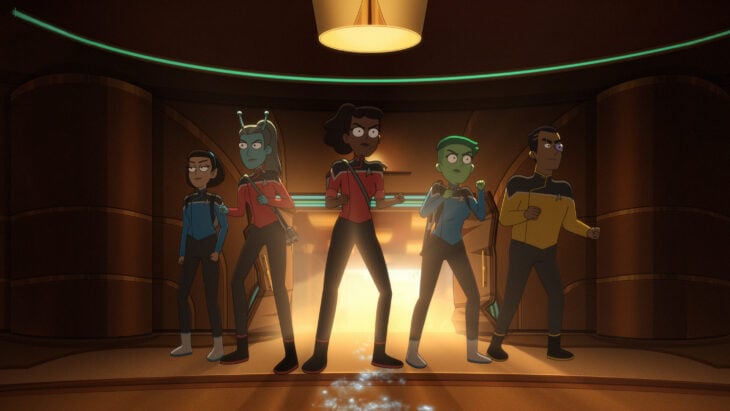 T'Lyn, Jennifer, Lt. Mariner, Lt. Tendi, and Lt. Rutherford brace themselves for a fight while standing in a dimly lit theater on Star Trek: Lower Decks Season 5 Episode 3, "The Best Exotic Nanite Hotel."
