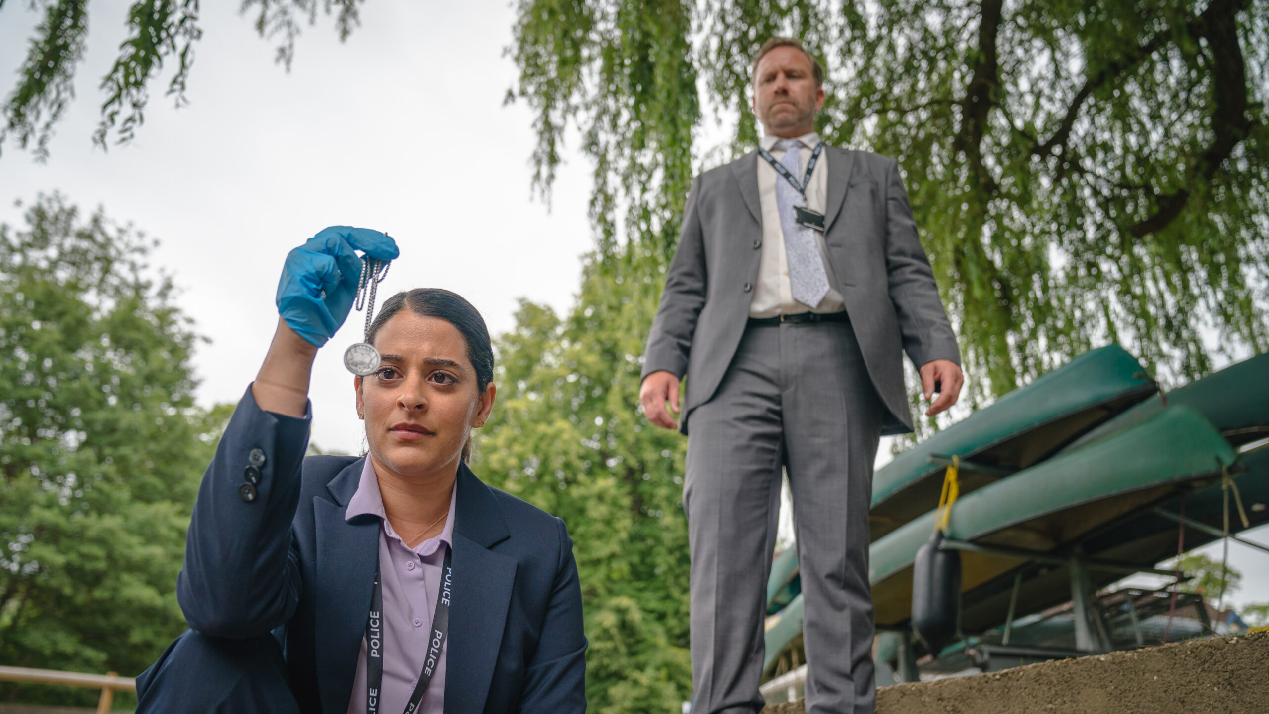THE MARLOW MURDER CLUB ON MASTERPIECE Season 1 Episode 3 - DS Tanika Malik, DS Brendan Perry | Tell-Tale TV Still from THE MARLOW MURDER CLUB ON MASTERPIECE Season 1 Episode 3 of Matalie Dew as DS Tanika Malik and Phill Langhorne as DS Brendan Perry pictured from left to right.
