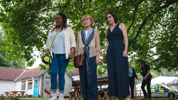 Still from THE MARLOW MURDER CLUB ON MASTERPIECE of Jo Martin as Suzie Harris, Samantha Bond as Judith Potts, and Cara Horgan as Becks Starling pictured from left to right.