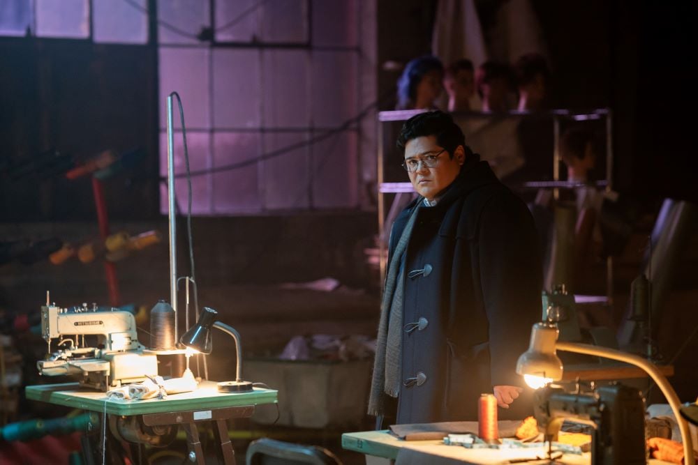 What We Do in the Shadows Season 6 Episode 5 Nandor's Army (3) | Tell-Tale TV Guillermo stands in a dimly lit abandoned warehouse on What We Do in the Shadows Season 6 Episode 5, "Nandor's Army."