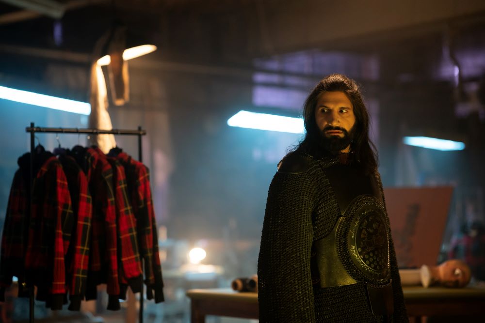 Nandor stands in a dimly lit abandoned warehouse on What We Do in the Shadows Season 6 Episode 5, "Nandor's Army."
