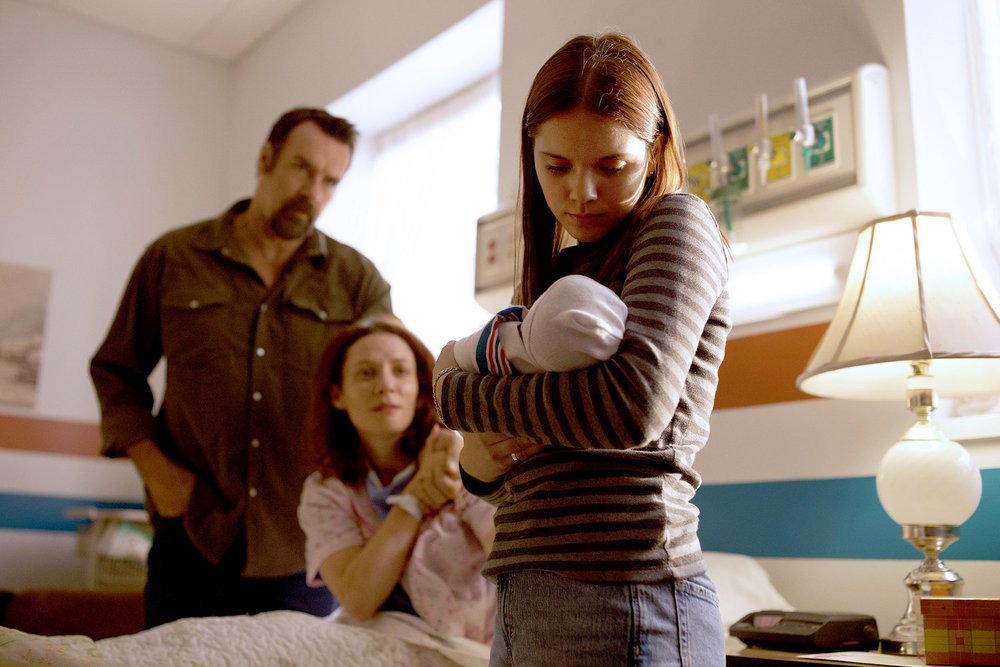 Revival Season 1 Episode 6 - David James Elliott, Lara Jean Chorostecki, and Reese Finlay | Tell-Tale TV Still from Revival Season 1 Episode 6 of David James Elliott as Sheriff Wayne Cypress, Lara Jean Chorostecki as Patty Cypress, and Reese Finlay as Teen Dana pictured from left to right.