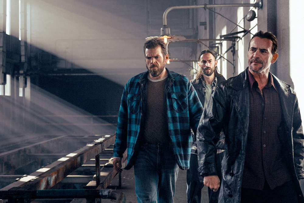 Still from Revival Season 1 Episode 6 of Matt Willis as Andrew Check, Joe Delfin as Adam Check, and Phil Brooks "CM Punk" as Anthony Check pictured from left to right.