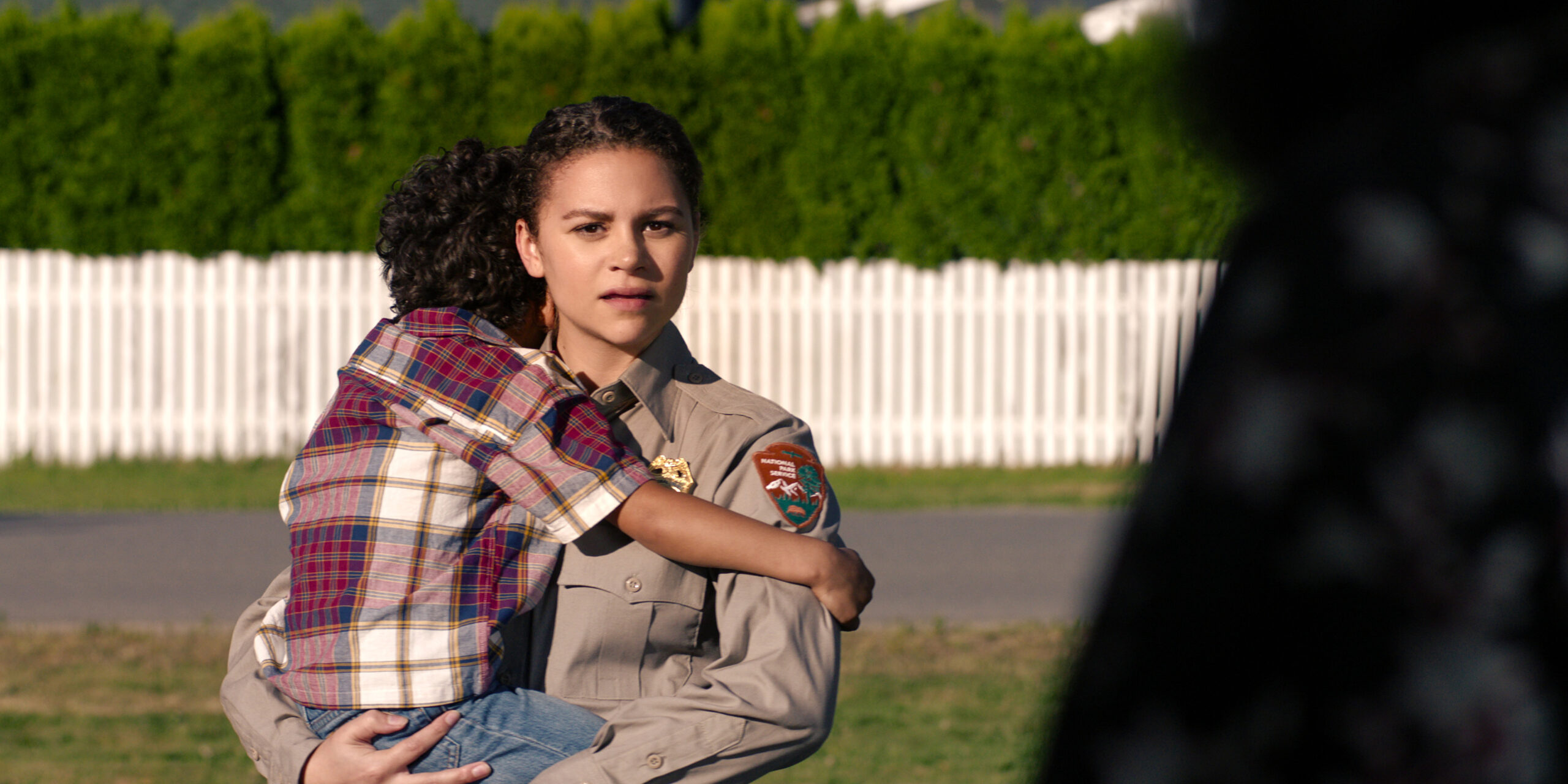 Lily Santiago as Naya Vasquez holding her son.