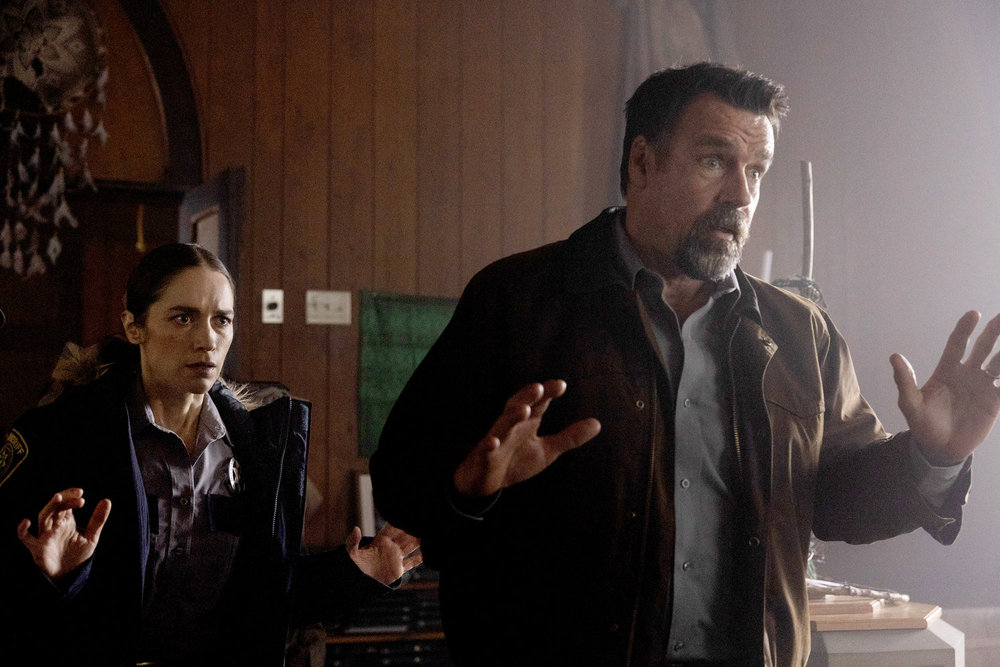 Still from Revival Season 1 Episode 10 of Melanie Scrofano as Dana Cypress and David James Elliott as Sheriff Wayne Cypress pictured left to right.