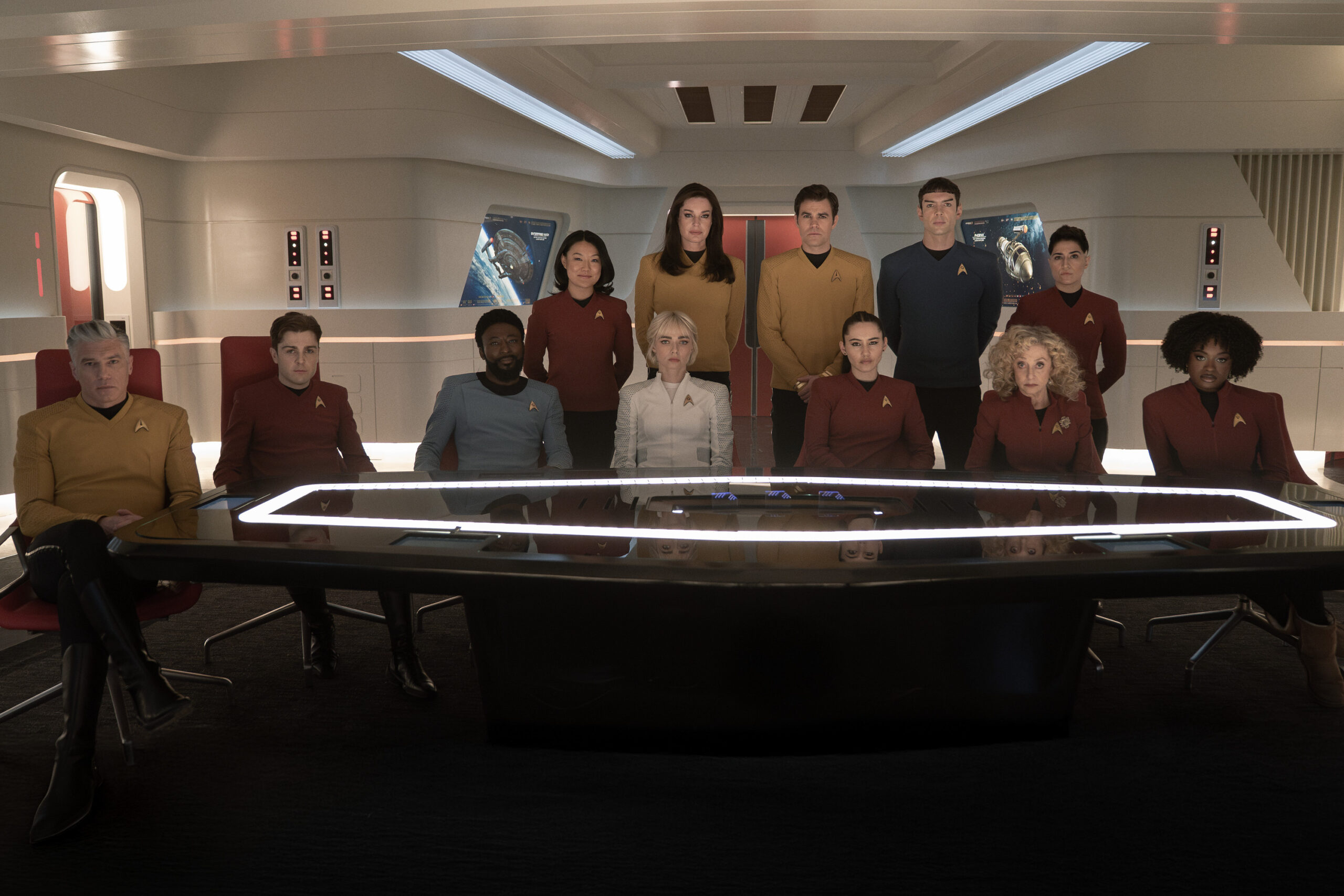 The Sehlat Who Ate Its Tail | Tell-Tale TV The cast of Star Trek: Strange New Worlds Season 3 Episode 6, "The Sehlat Who Ate Its Tail," sits in the ready room aboard the Enterprise, posing for a photo.