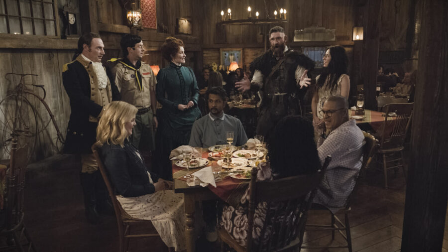 “Viking Wedding” – GHOSTS Season 5 Episode 2. Pictured (L-R): Brandon Scott Jones as Isaac, Richie Moriarty as Pete, Rose McIver as Samantha, Rebecca Wisocky as Hetty, Utkarsh Ambudkar as Jay, Devan Chandler Long as Thorfinn, and Sheila Carrasco as Flower. Photo: CBS ©2025 CBS Broadcasting, Inc. All Rights Reserved. Highest quality screengrab available.