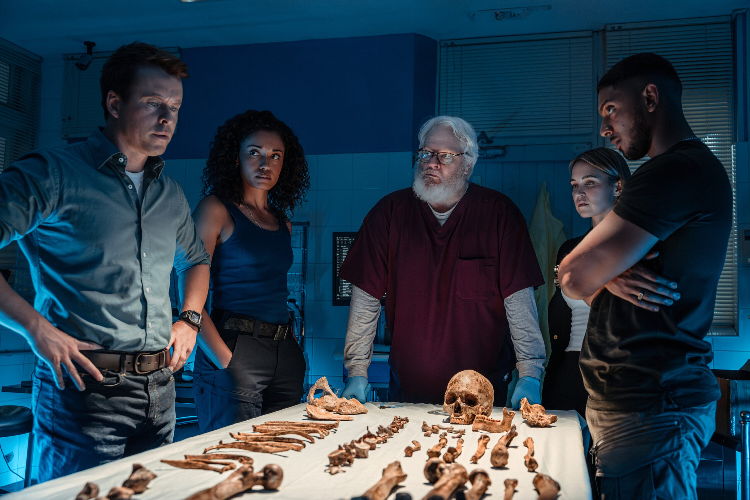 NCIS: Sydney Season 3 Episode 2, "True Blue" -- Todd Lasance as AFP Liaison Officer Sergeant Jim 'JD' Dempsey, Olivia Swann as NCIS Special Agent Captain Michelle Mackey, William McInnes as Forensic Pathologist Dr. Roy Penrose, Tuuli Narkle as AFP Liaison Officer Constable Evie Cooper and Sean Sagar as NCIS Special Agent DeShawn Jackson