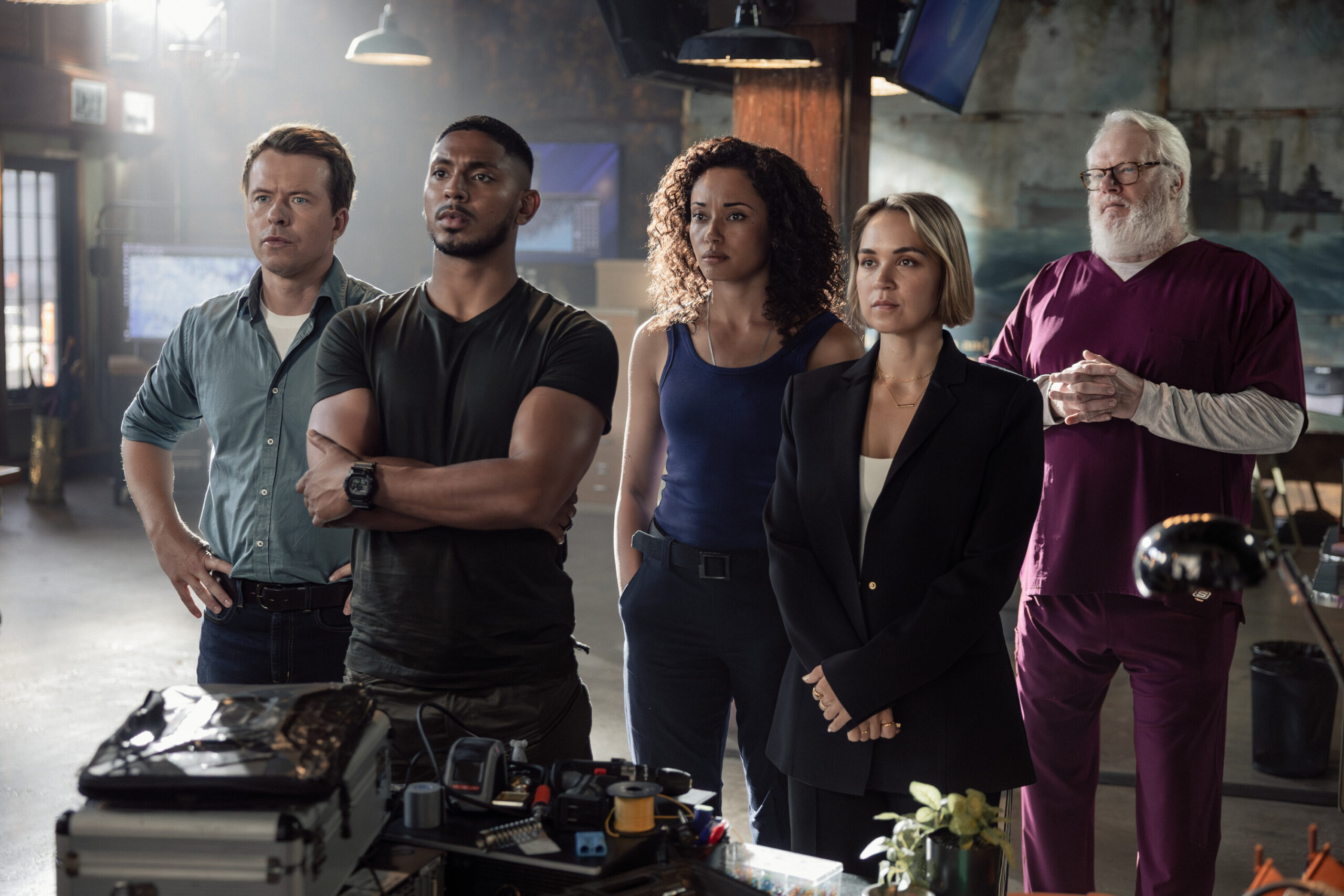 NCIS: Sydney Season 3 Episode 2, "True Blue" -- Todd Lasance as AFP Liaison Officer Sergeant Jim 'JD' Dempsey, Sean Sagar as NCIS Special Agent DeShawn Jackson, Olivia Swann as NCIS Special Agent Captain Michelle Mackey, Tuuli Narkle as AFP Liaison Officer Constable Evie Cooper, and William McInnes as Forensic Pathologist Dr. Roy Penrose