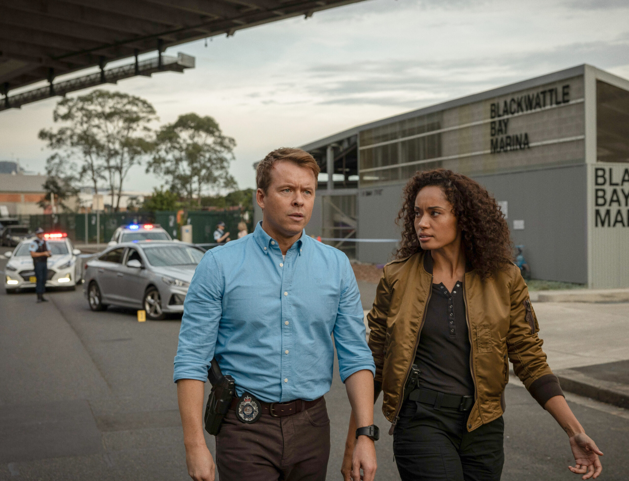 NCIS: Sydney Season 3 Episode 7, "Gold Digger" -- Todd Lasance as AFP Liaison Officer Sergeant Jim 'JD' Dempsey and Olivia Swann as NCIS Special Agent Captain Michelle Mackey