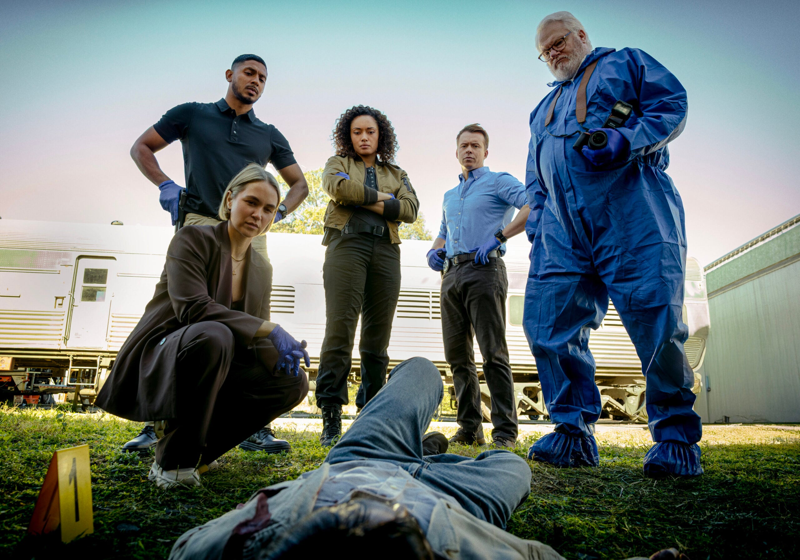 NCIS: Sydney Season 3 Episode 7, "Gold Digger" -- Tuuli Narkle as AFP Liaison Officer Constable Evie Cooper, Sean Sagar as NCIS Special Agent DeShawn Jackson, Olivia Swann as NCIS Special Agent Captain Michelle Mackey, Todd Lasance as AFP Liaison Officer Sergeant Jim 'JD' Dempsey and William McInnes as Forensic Pathologist Dr. Roy Penrose