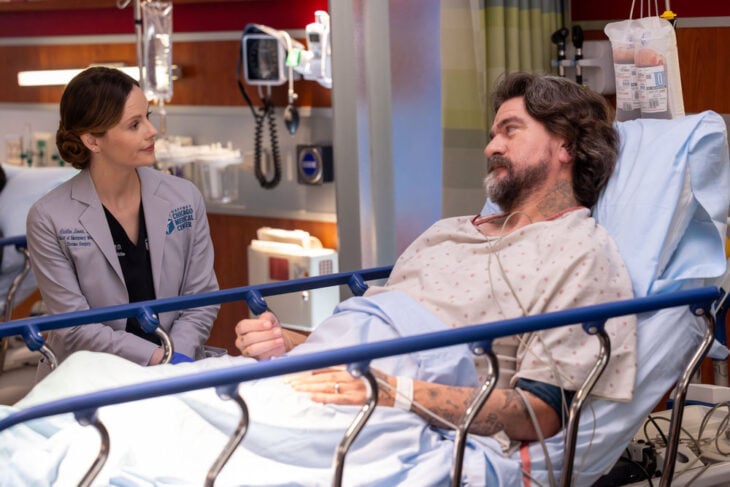 Chicago Med Season 11 Episode 6, "The Story of Us" - (l-r) Sarah Ramos as Dr. Caitlin Lenox and Charles Halford as Jabo Higgins