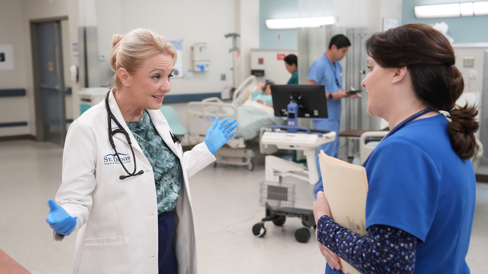 Wendi McLendon-Covey as Joyce and Allison Tolman as Alex on St. Denis Medical Season 2 Episode 6, "I Left a Woman on the Table."