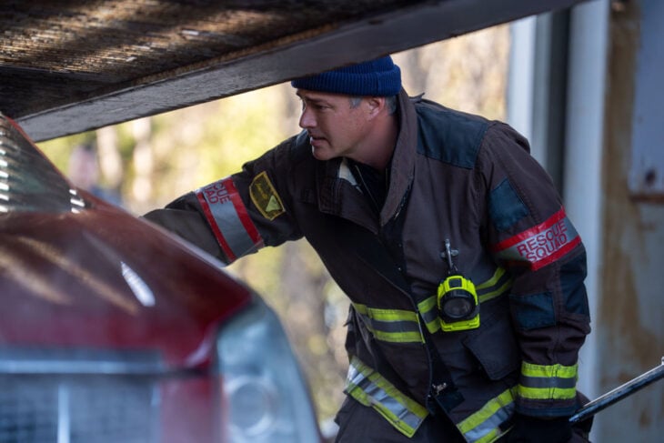 Taylor Kinney as Kelly Severide looking inside a car. Chicago Fire Season 14 Episode 10 Review: Carry a Torch - Part 2 