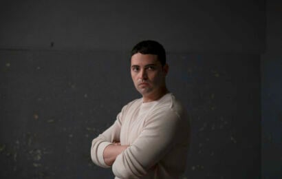 Benjamin Levy Aguilar as Dante Torres standing in an interrogation room. Chicago P.D. Season 13 Episode 10 Review: Faith 