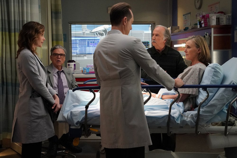 Sarah Ramos as Dr. Caitlin Lenox, Oliver Platt as Dr. Daniel Charles, Mark Linn-Baker as Dr. Howie Mankiewicz, Brenda Strong as Dr. Suzie Mankiewicz standing in a hospital room.