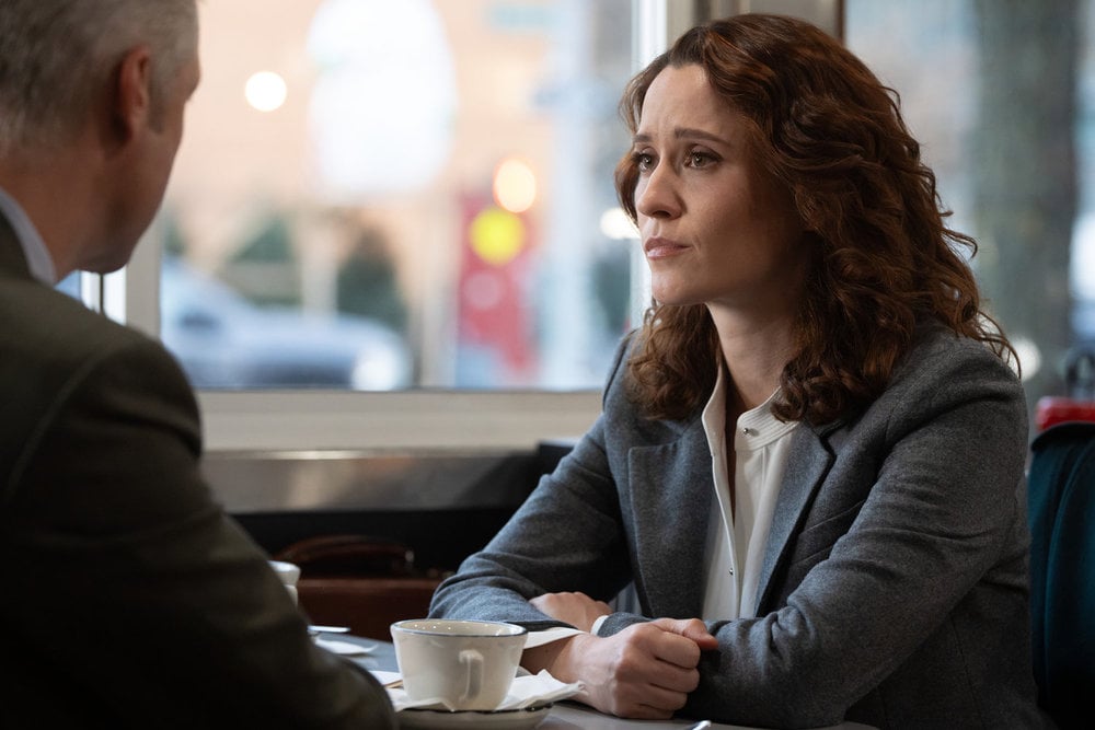 Norma Kuhling as ADA CJ Jones sitting at a diner.
