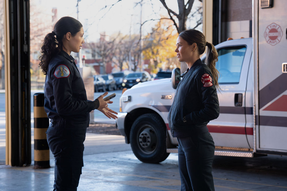 Miranda Rae Mayo as Stella Kidd, Jocelyn Hudon as Lyla Novak talking by the ambulance.