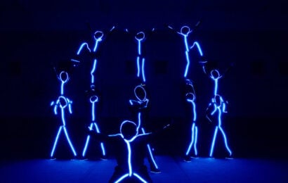 Stumble Season 1 Episode 9, "Lights Out," - Performance group onstage in blacklight outfits. Stumble Season 1 Episode 9 Review: Lights Out 