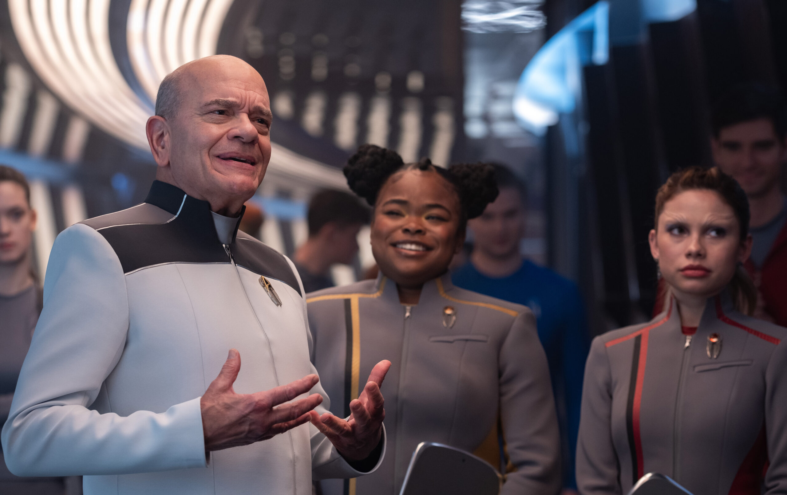Still from Star Trek: Starfleet Academy Season 1 Episode 1 of Robert Picardo as The Doctor, Kerrice Brooks as Sam and Bella Shepard as Genesis pictured from left to right.
