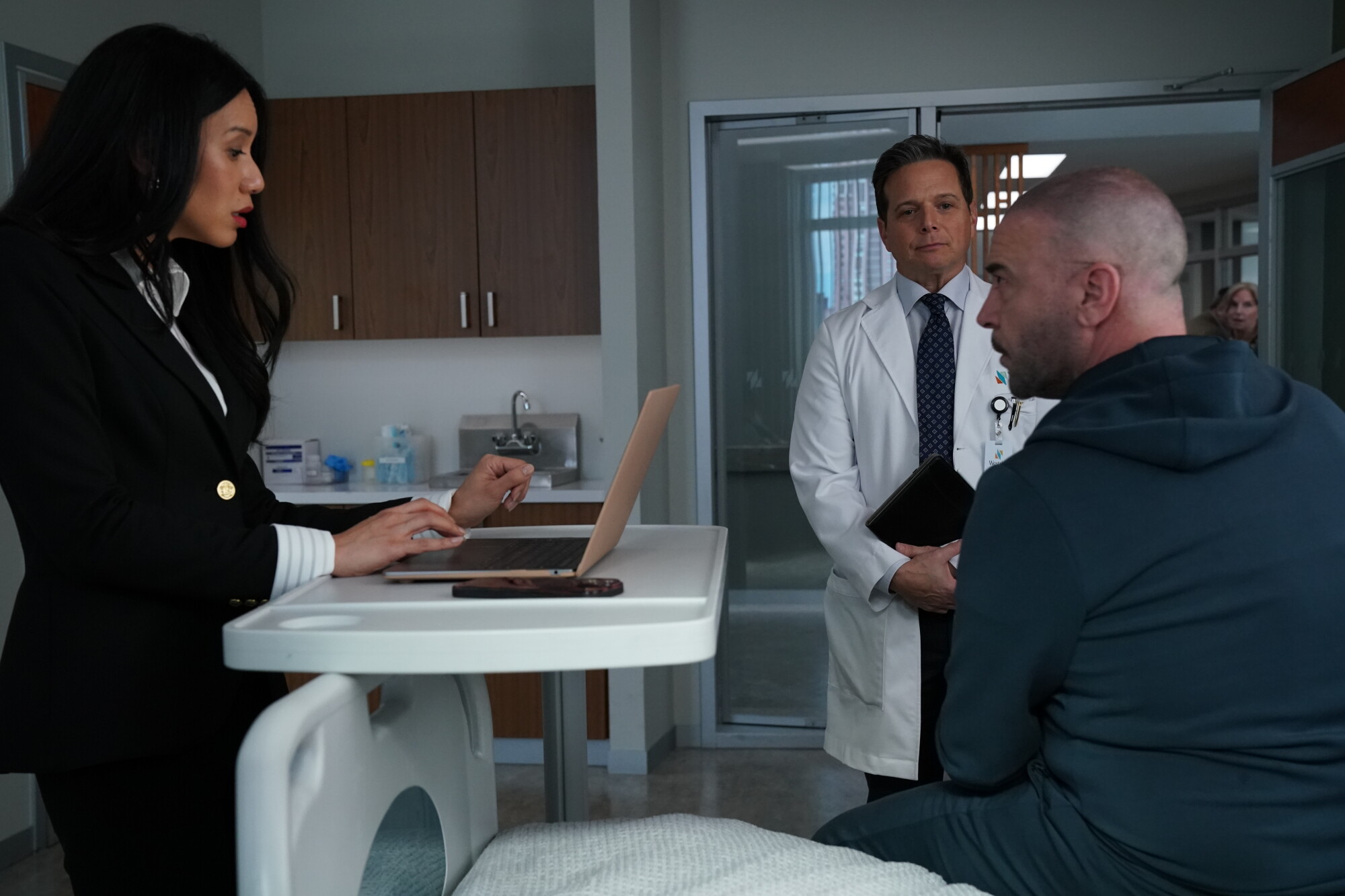 Still from Doc Season 2 Episode 17 of Elena Juatco, Scott Wolf, and Alan Van Sprang pictured from left to right.