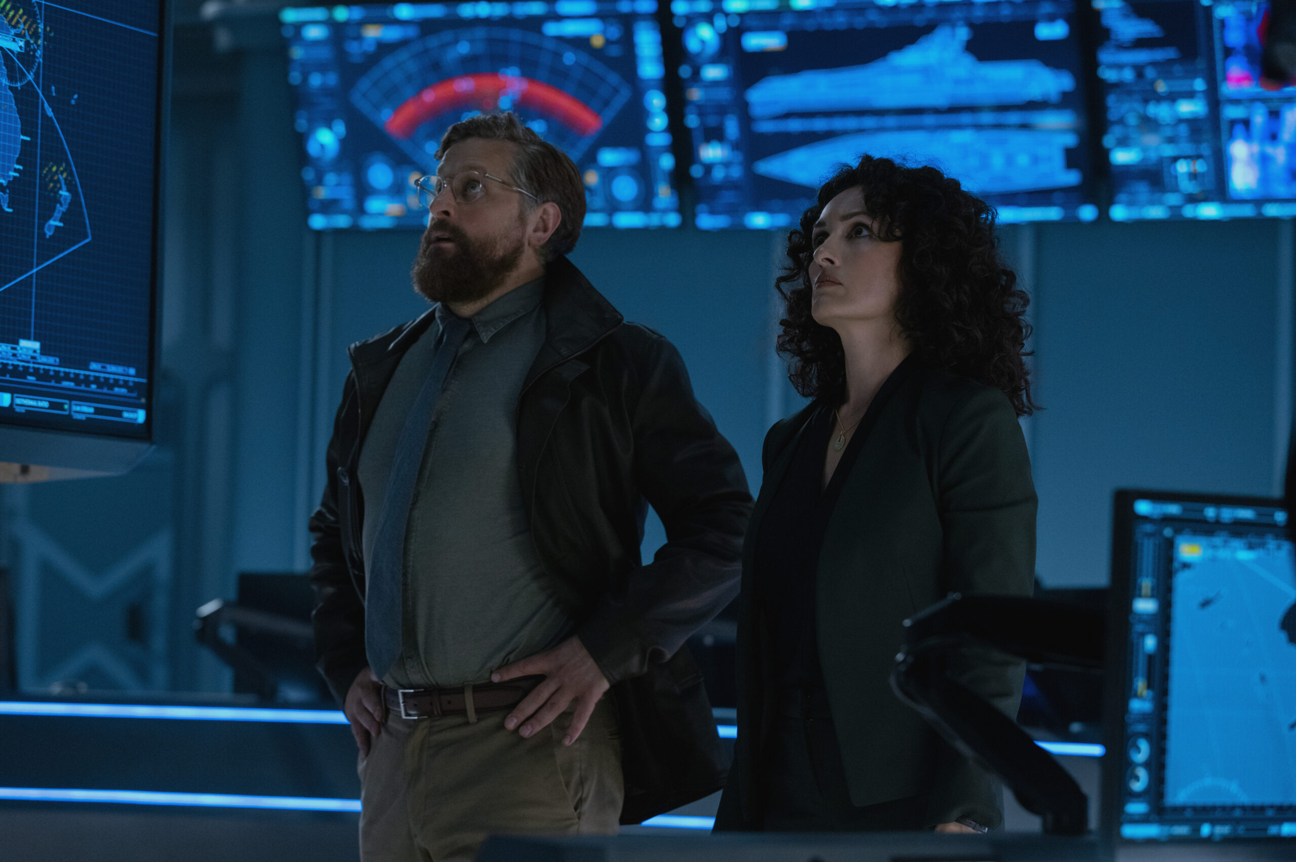 Monarch: Legacy of Monsters Season 2 Episode 6 - Joe Tippett and Mirelly Taylor | Tell-Tale TV Still from Monarch: Legacy of Monsters Season 2 Episode 6 of Joe Tippett and Mirelly Taylor pictured from left to right.