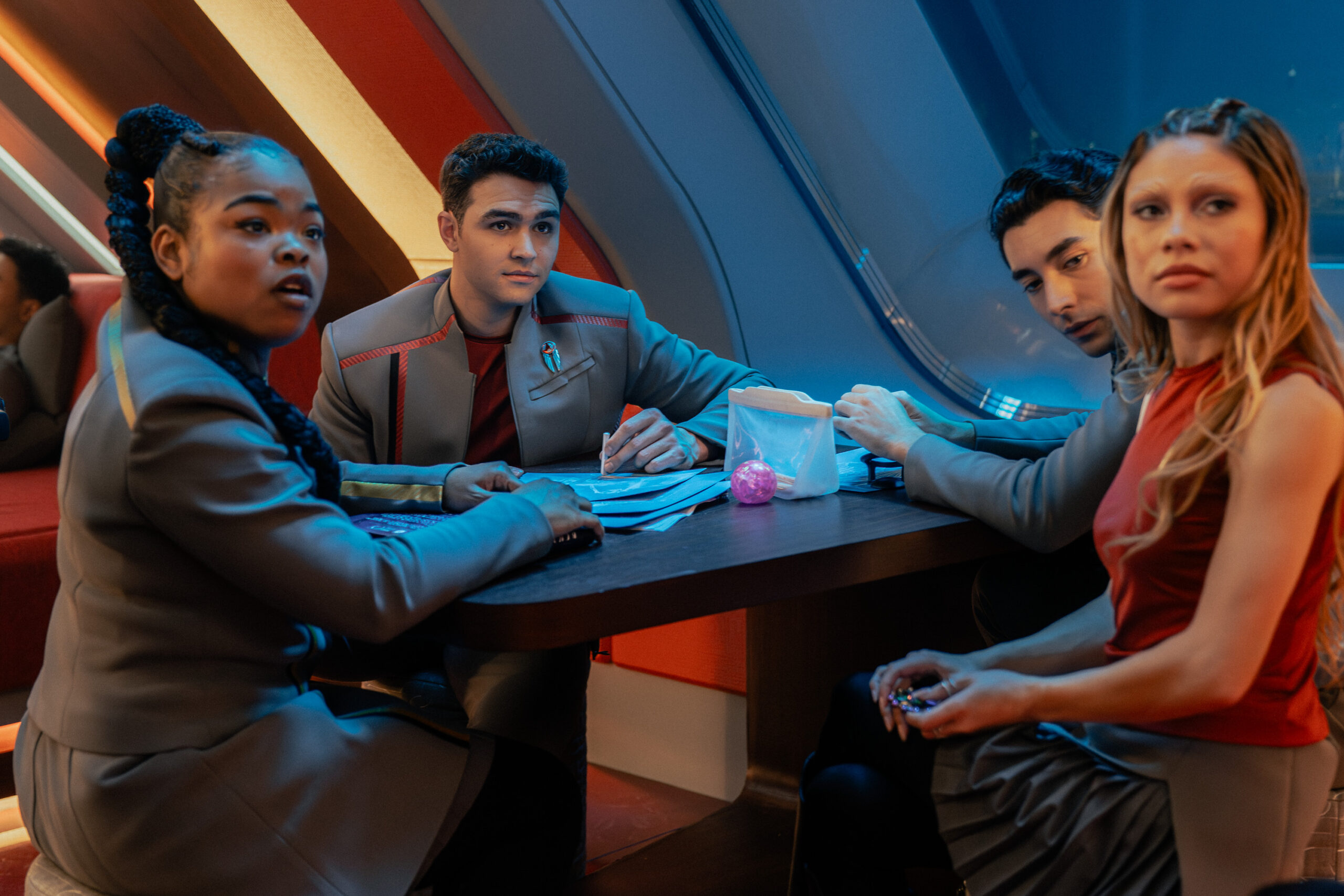 Still from Star Trek: Starfleet Academy Season 1 Episode 5 of Kerrice Brooks as SAM, George Hawkins as Darem, Romeo Carere as Ocam, and Bella Shepard as Genesis pictured from left to right.