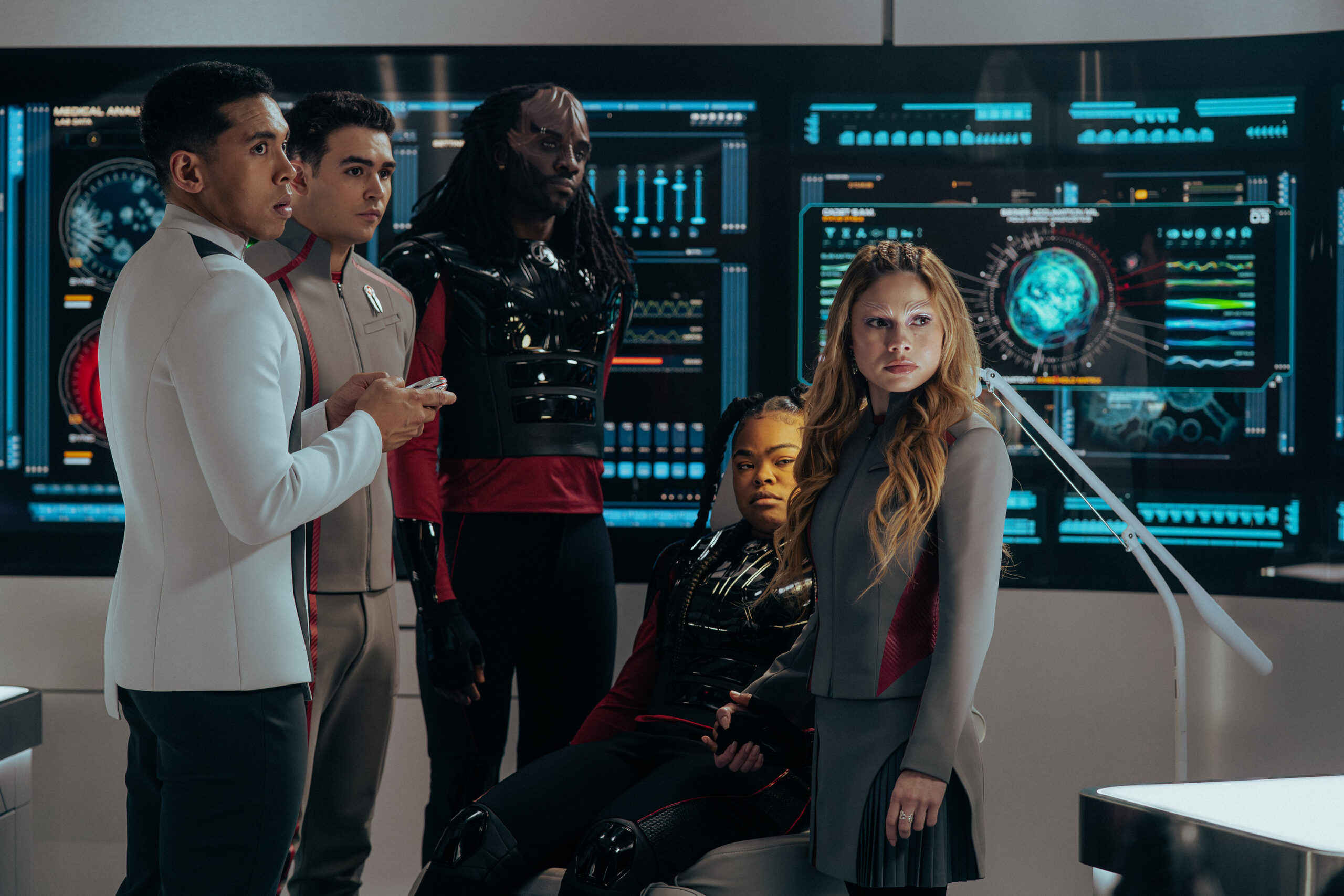Still from Star Trek: Starfleet Academy Season 1 Episode 6 of Sandro Rosta as Caleb, George Hawkins as Darem, Karim Diané as Jay-Den, Kerrice Brooks as SAM, and Bella Shepard as Genesis pictured from left to right.