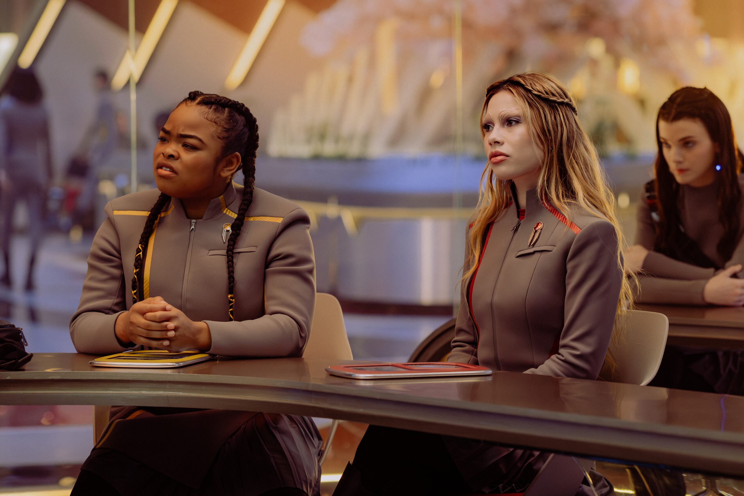 Star Trek: Starfleet Academy Temporada 1, Episódio 8 - Caris Brooks e Bella Shepard | televisão reveladora Still de Star Trek: Starfleet Academy Temporada 1, Episódio 8, The Life of the Stars, na foto da esquerda para a direita estão Kerris Brooks como SAM e Bella Shepard como Genesis.
