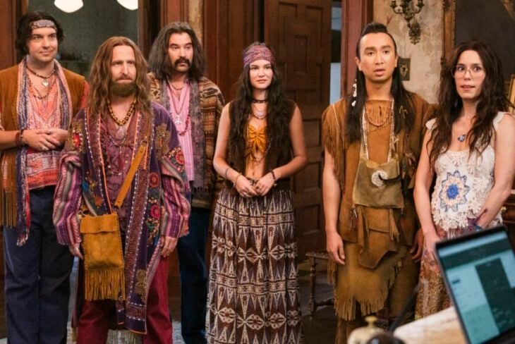 “The Others” – GHOSTS. Pictured: Will Greenberg as Bruce, Román Zaragoza as Sasappis, and Sheila Carrasco as Flower (Bertrand Calmeau/CBS) | Tell-Tale TV “The Others” – GHOSTS. Pictured: Will Greenberg as Bruce, Román Zaragoza as Sasappis, and Sheila Carrasco as Flower (Bertrand Calmeau/CBS) Ghosts Season 5 Episode 11 Review: The Others