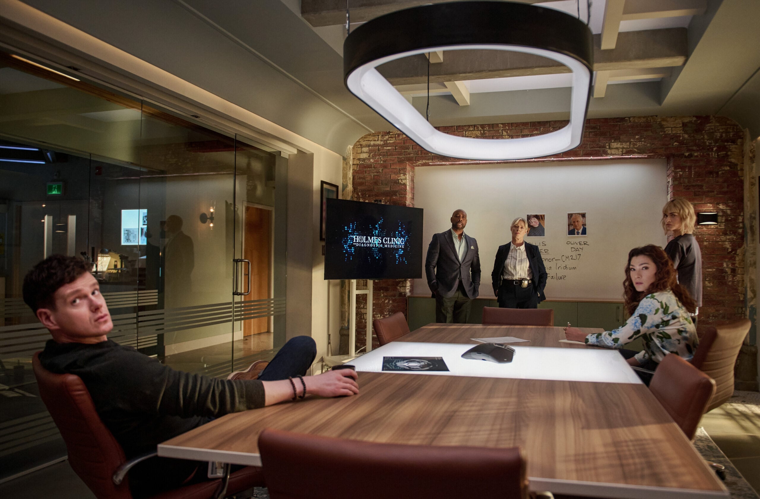 Watson Season 2 Episode 15, "A Third Act Surprise" - (l-r) Peter Mark Kendall as Dr. Adam Croft, Morris Chestnut as Dr. John Watson, Rachel Hayward as Det. Lestrade, Eve Harlow as Dr. Ingrid Derian, and Inga Schlingmann as Dr. Sasha Lubbock.