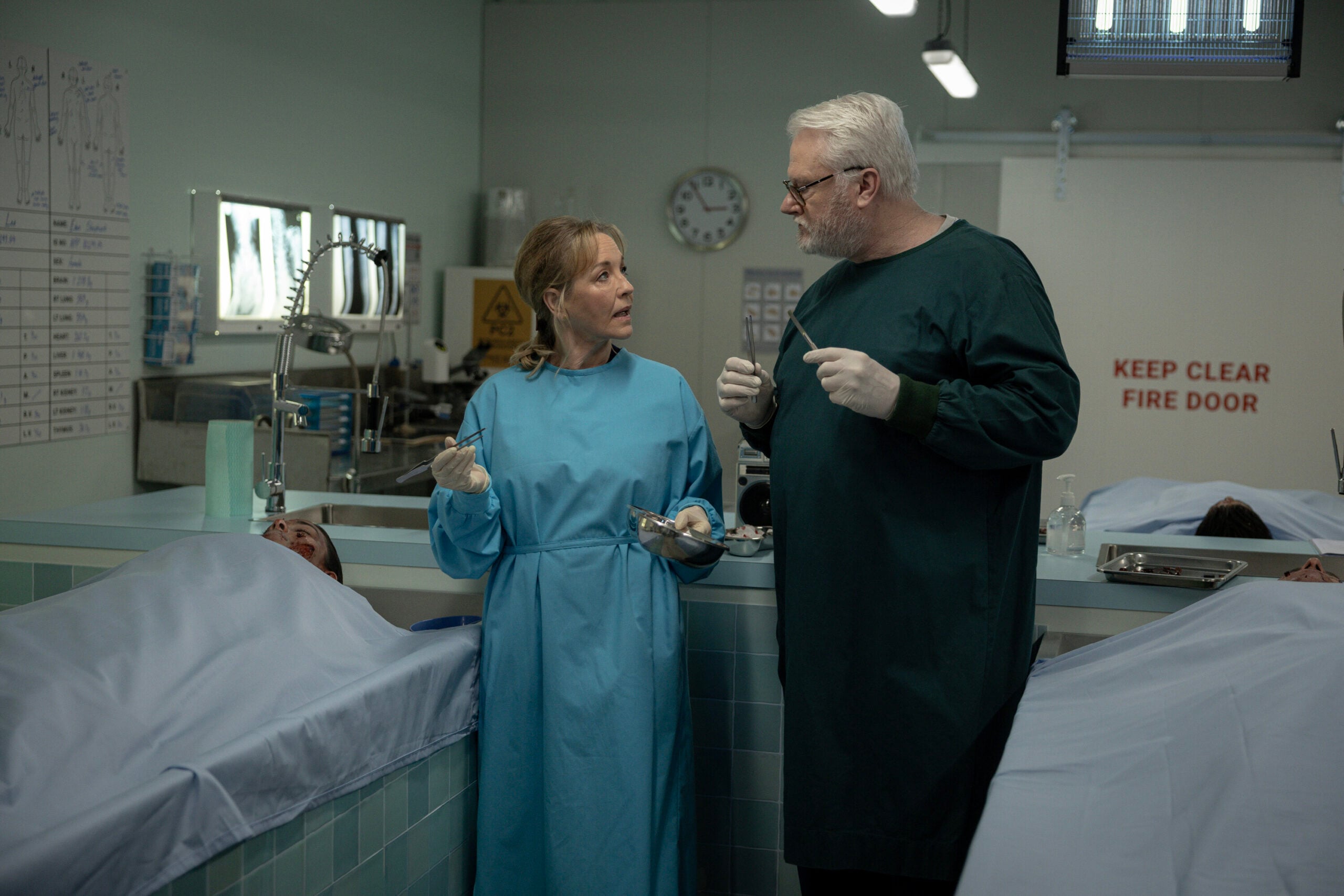 NCIS: Sydney Season 3 Episode 12, "Lone Wolf: Part One" -- Rebecca Gibney as Nia Williams and William McInnes as Forensic Pathologist Dr. Roy Penrose